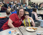 Families enjoying breakfast at a Read Across America event.